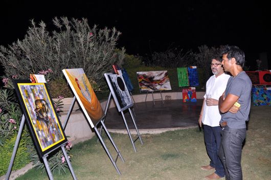 Artist Apurva Choubey shows Milind Soman his paintings
