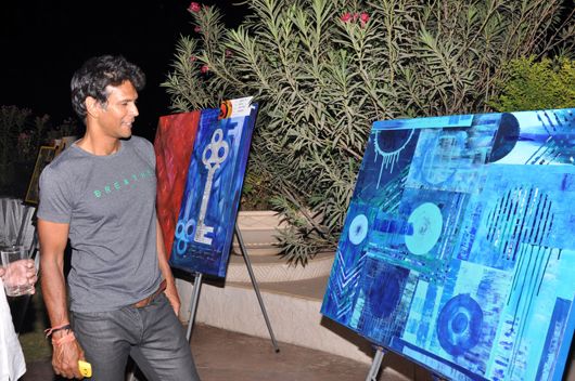 Milind Soman checks out paintings by Apurva Choubey for auction