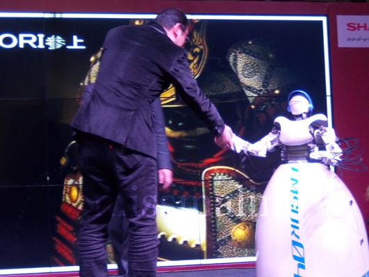 The robot shakes hands with a dignitary
