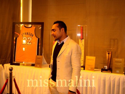 Rahul Bose admires Magic Johnson's autographed jersey, donated by the NBA