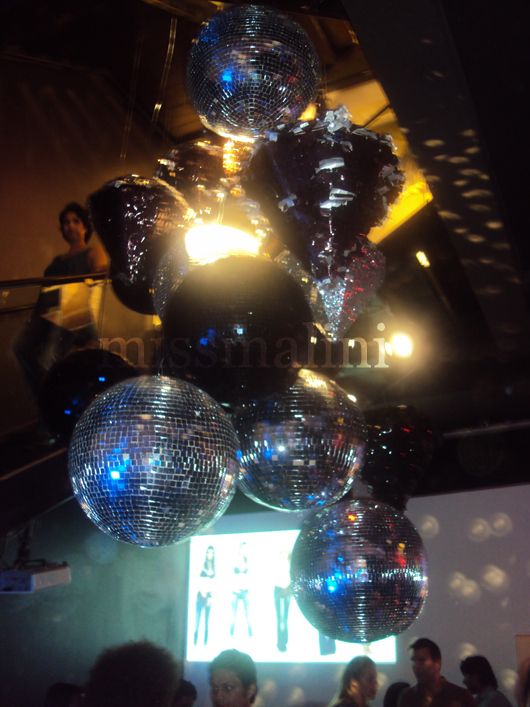 Shiny disco balls hang from the ceiling of the Diesel boutique
