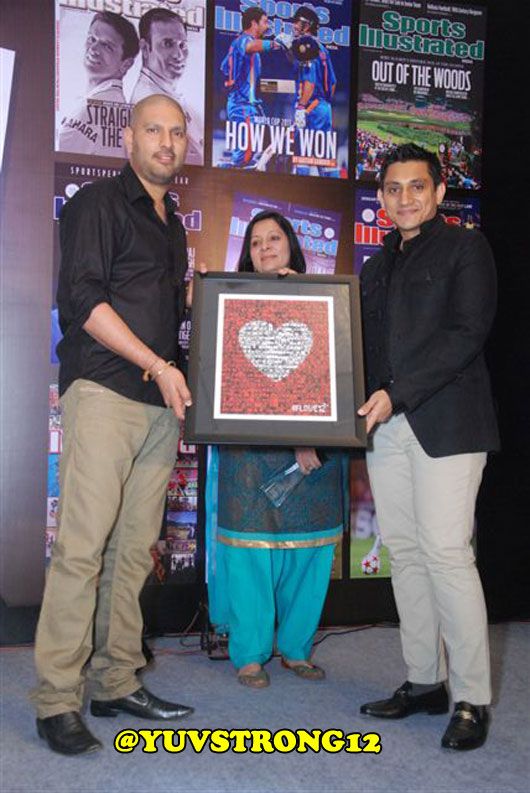 Rajiv Mehta, the MD of PUMA South-Asia, presents Brand Ambassador Yuvraj Singh with the #love12 poster, made by Yuvi's fans