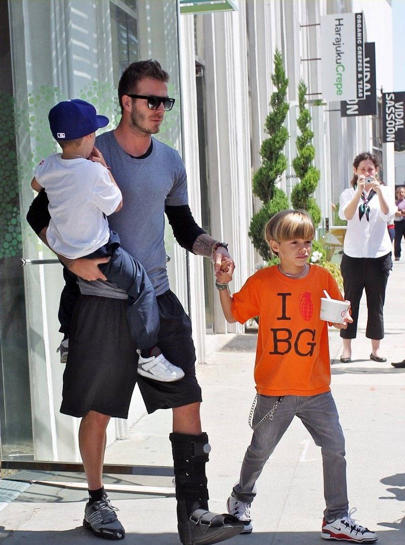 David Beckham with his boys coming out of a Pinkberry store