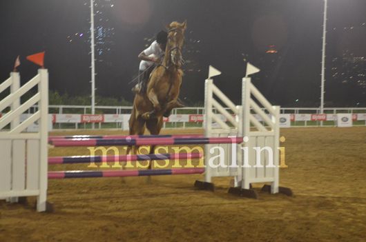 A contestant has his horse jump a barrier