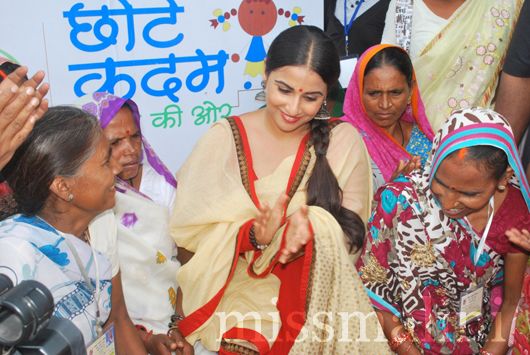 Vidya encouraging the women's self-help group to continue their work on education
