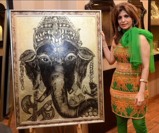 Beena Aziz with with her paintings