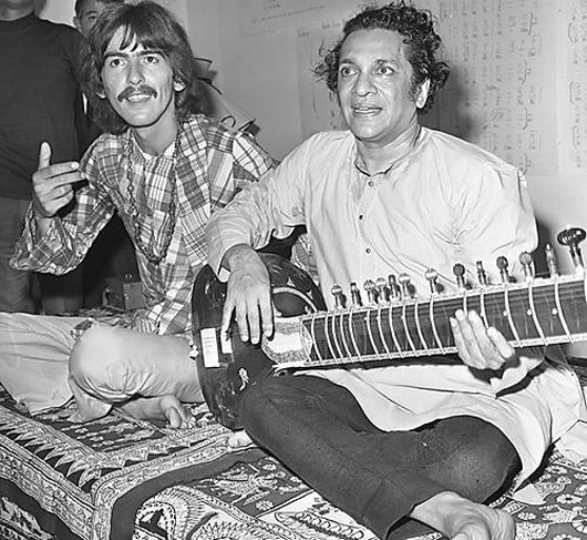 Pandit Ravi Shankar performs with George Harrison of The Beatles