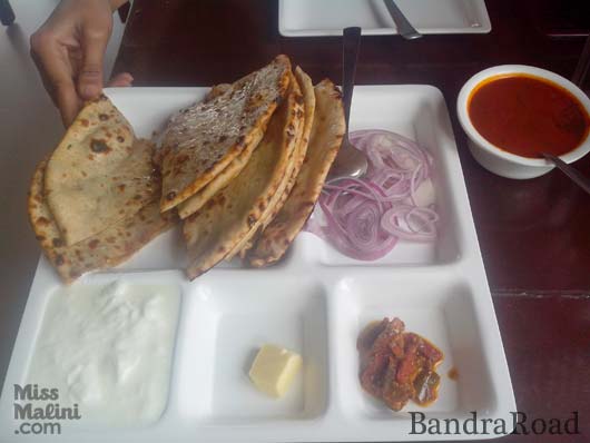Delhi Belly's kheema parathas served with mutton curry, butter, yogurt and Punjabi mango pickle.