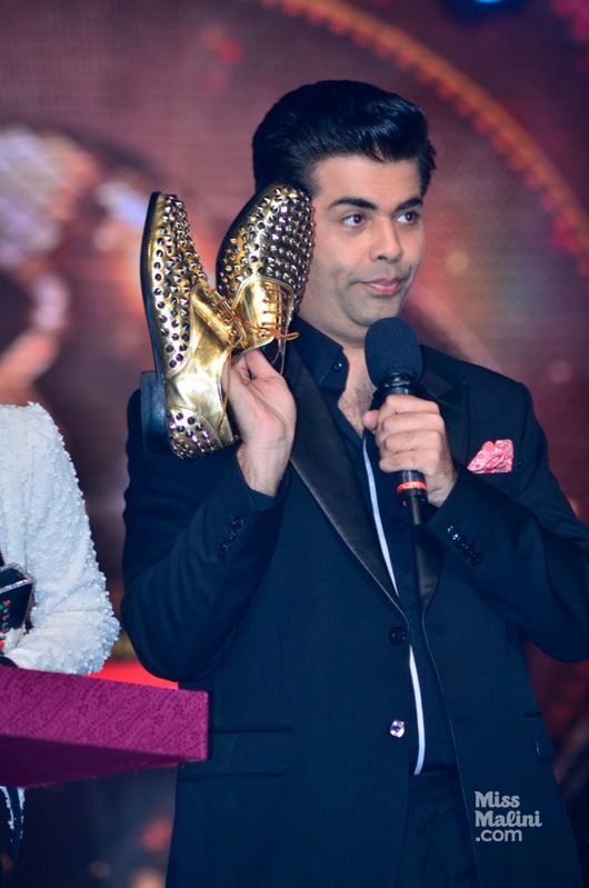 Karan Johar showing the Dancing shoes