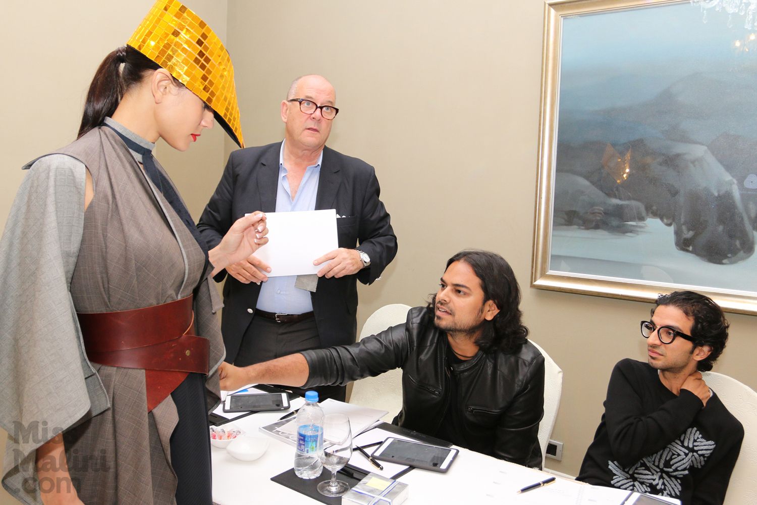 Rahul Mishra inspects a garment by Bird on a Wire with Imran Amed and Peter Ackroyd