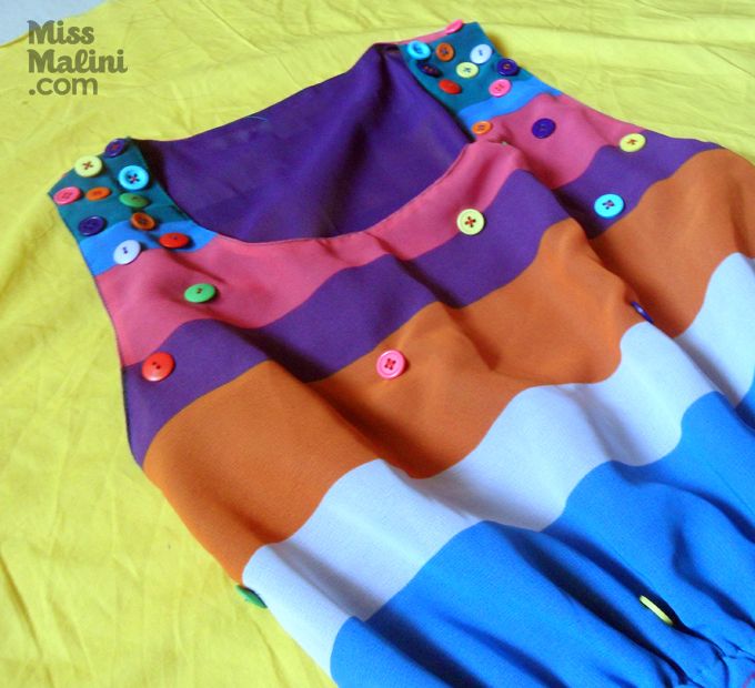 Coloured buttons stitched on to a colour blocked dress.