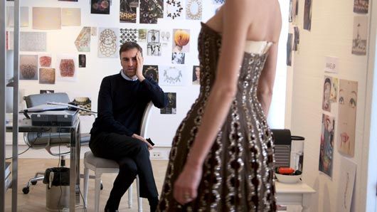 New Dior designer Raf Simons looks at a vintage Dior dress from the documentary DIOR & I, directed by Frédéric Tcheng. Courtesy of CIM Productions