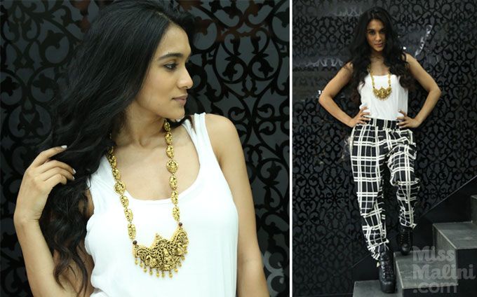Temple jewellery style with layered white tank tops and checked pants.