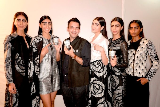 Nachiket Barve and his models holding Barve's specially designed cup