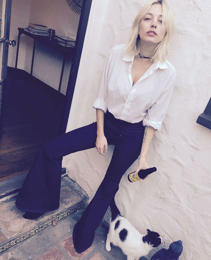 Making the white shirt cool with a pair flared '70s trousers. (Pic: @carolinavreeland on Instagram)