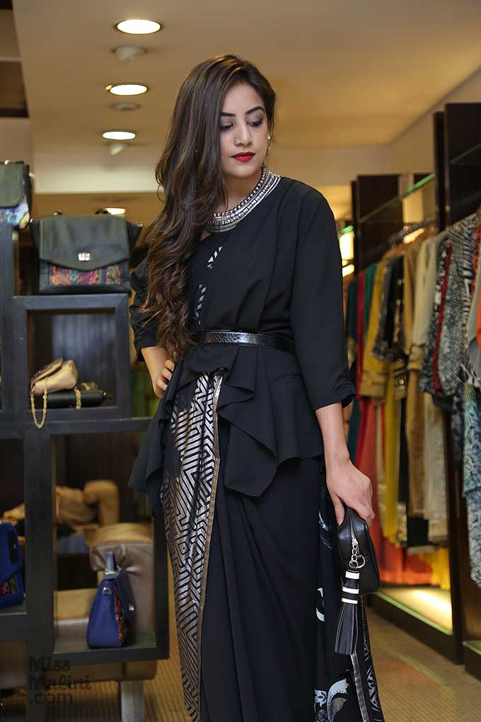 Complete the look with a statement necklace and a box clutch by Satya Paul.