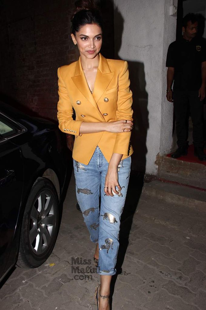 Deepika Padukone's dinner time look in a bright blazer and art-patched jeans.