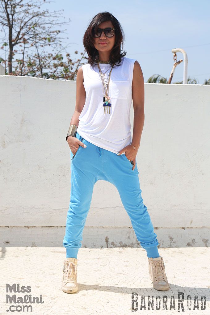 Malini wearing our BandraRoad, drop-crotch, vintage blue, Dylan joggers and white cut-off tank.