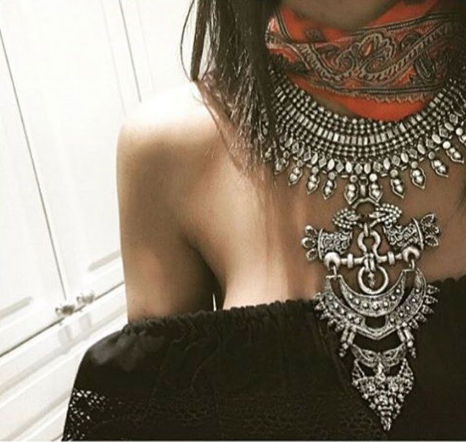 Chunky silver neck piece over bare skin. (Source: @stolenfrommysister on Instagram)