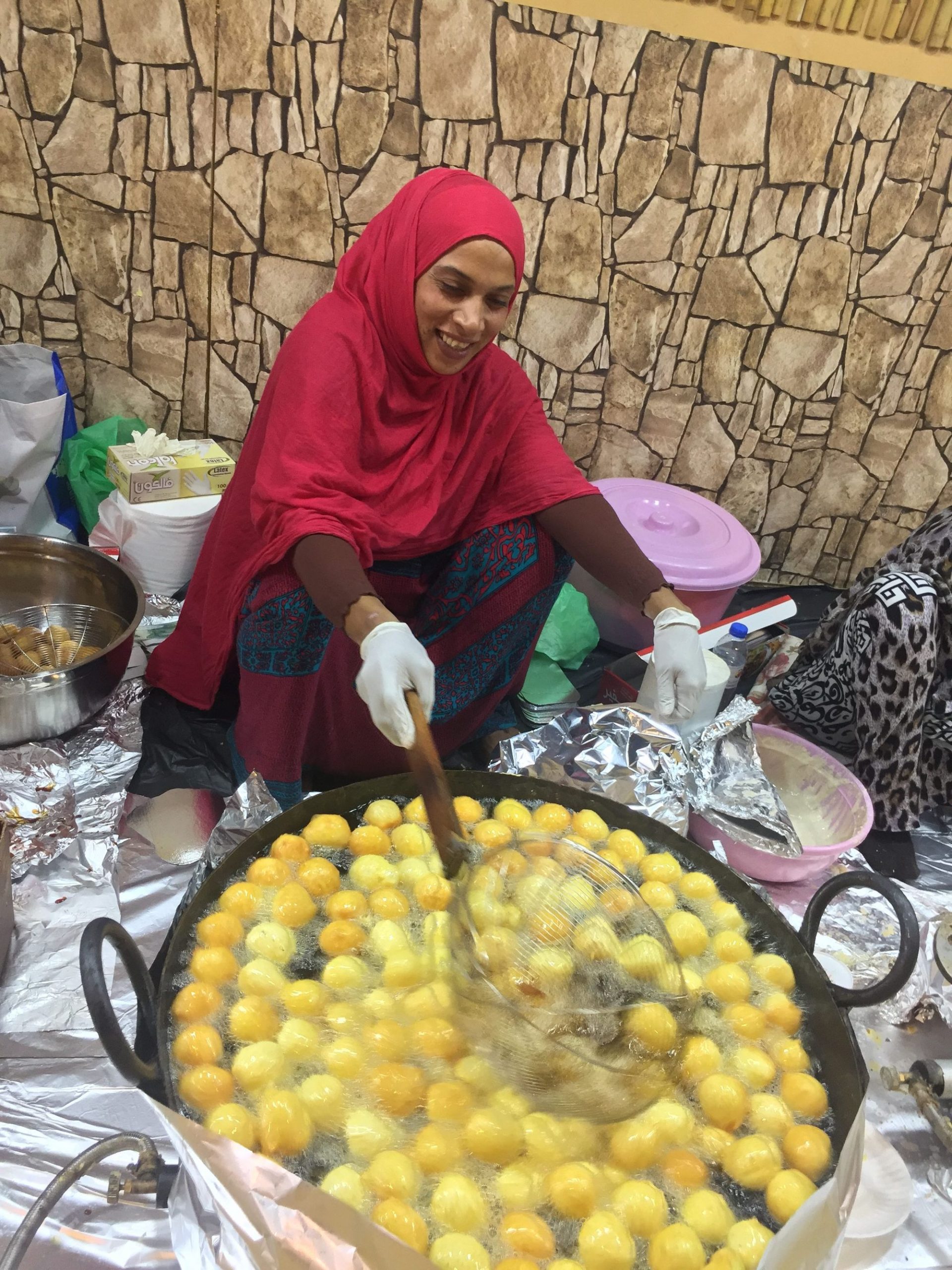 An Emirati woman whips up the famous Loqemat