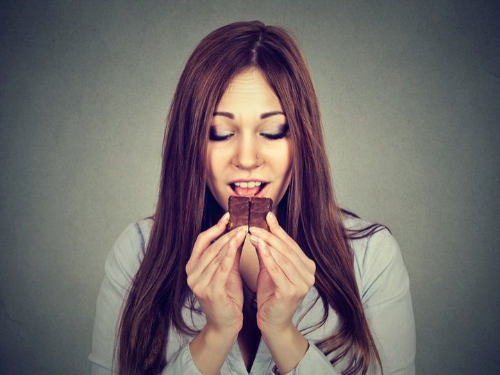 Woman Eating Chocolate (Image Courtesy: Shutterstock)