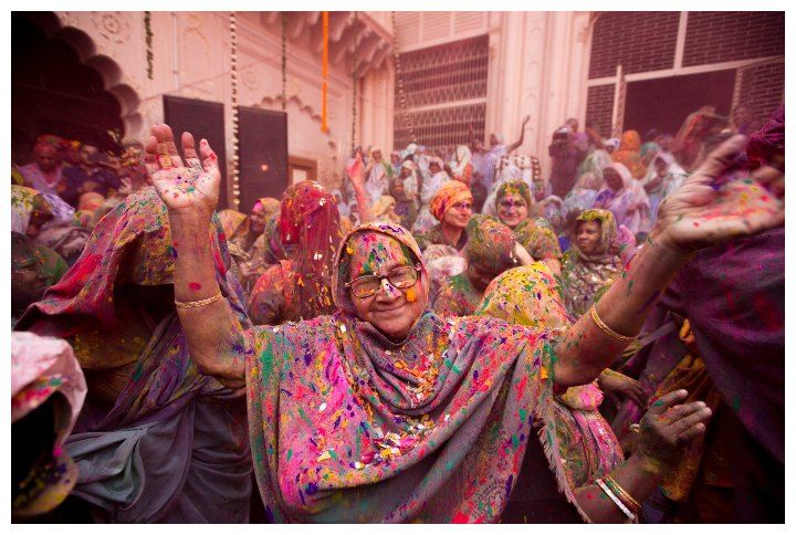 An Indian widow celebrating Holi at Gopinath Temple in Vrindavan, India by SatpalSingh | www.shutterstock.com