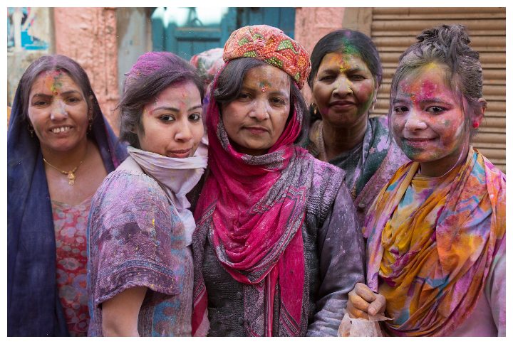 A group of women celebrating Holi festival in the streets of Vrindavan, India by Kimrawicz | www.shutterstock.com