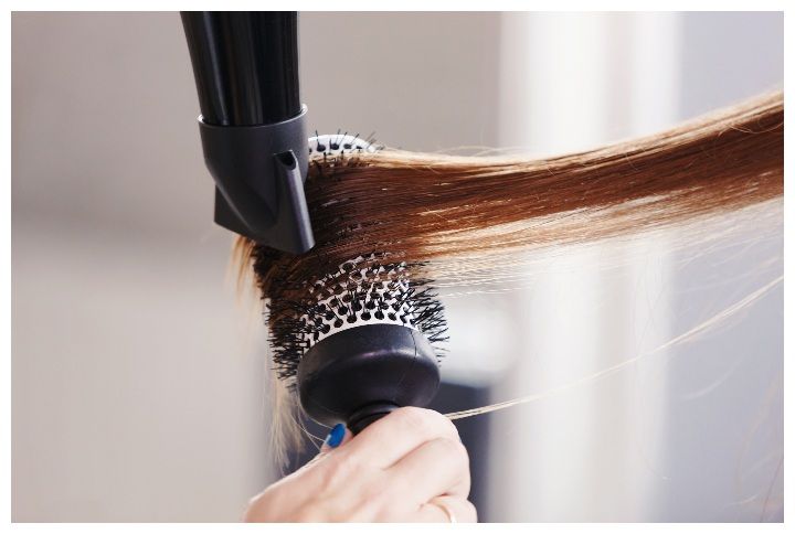 Hairdresser dries hair with a hairdryer in beauty salon by ZephyrMedia | (Source: www.shutterstock.com)