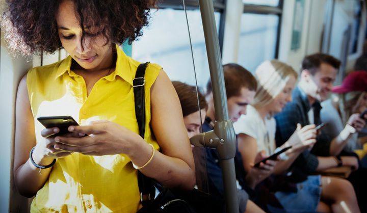 Young woman using a smartphone in a subway By Rawpixel.com | www.shutterstock.com