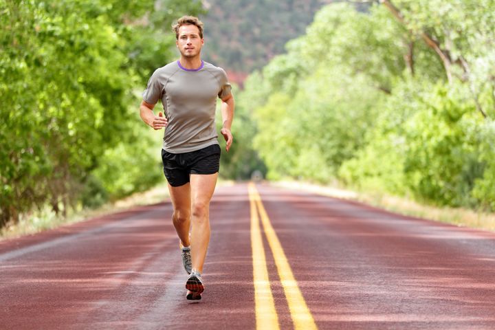 Sport and fitness runner man running on road training for marathon run doing high intensity interval training sprint workout outdoors in summer. Male athlete sports model fit and healthy aspirations. By Maridav | www.shutterstock.com