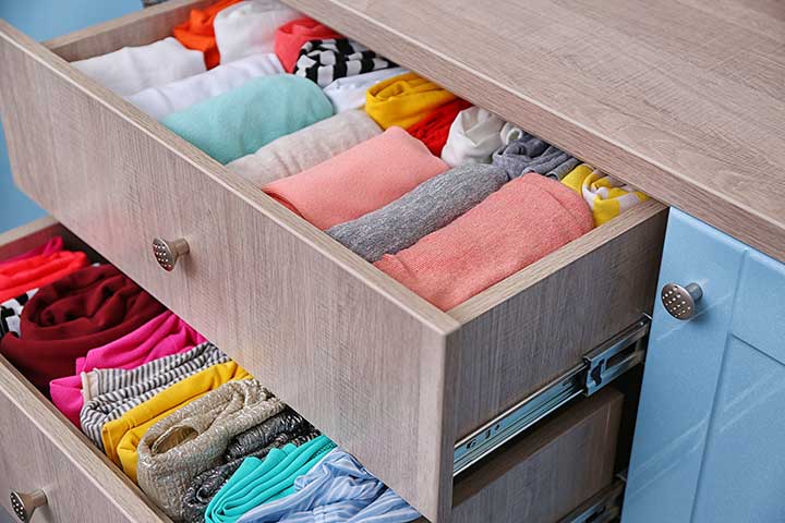 Neatly Folded Clothes In A Drawer by Africa Studio | www.shutterstock.com
