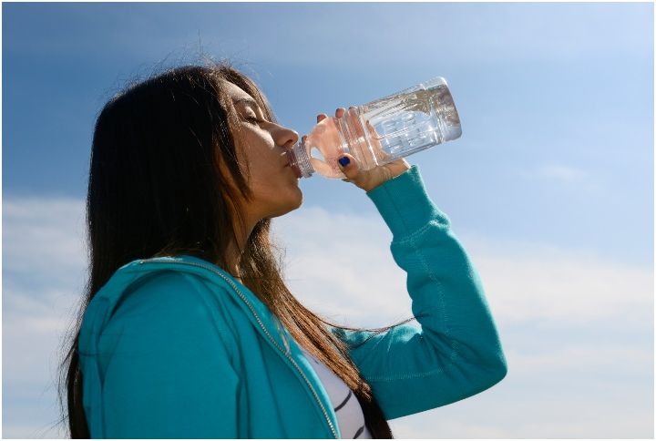 Indian girl drinking water after exercising by Reimar | www.shutterstock.com