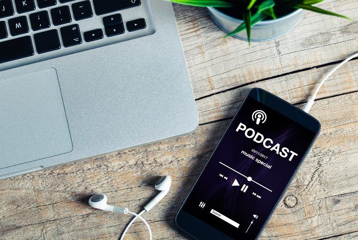 Podcast app in a mobile phone at the office By David MG | www.shutterstock.com