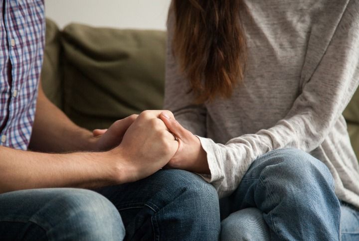 Couple Holding Hands By fizkes | www.shutterstock.com