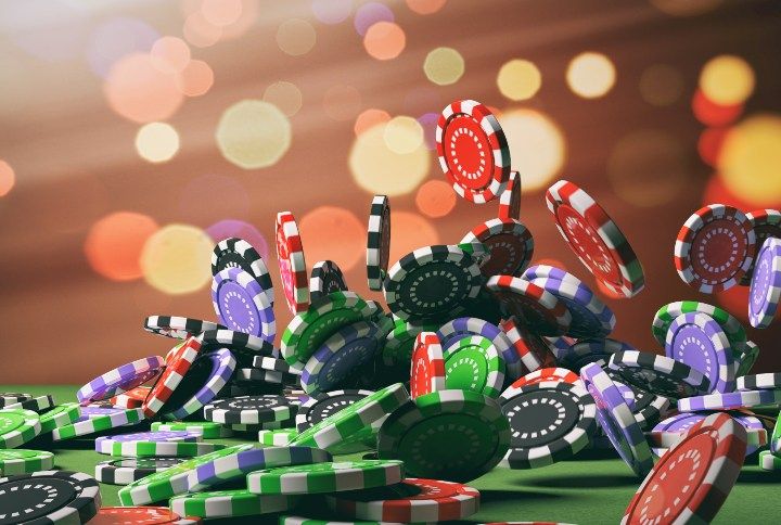 Casino poker chips falling on green felt background. 3d illustration R By rawf8 | www.shutterstock.com