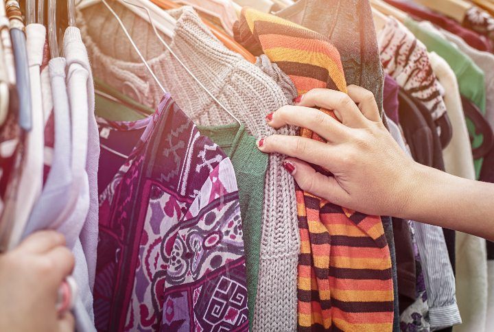 close up of a hand, looking on a flea market for clothes By Armin Staudt | www.shutterstock.com