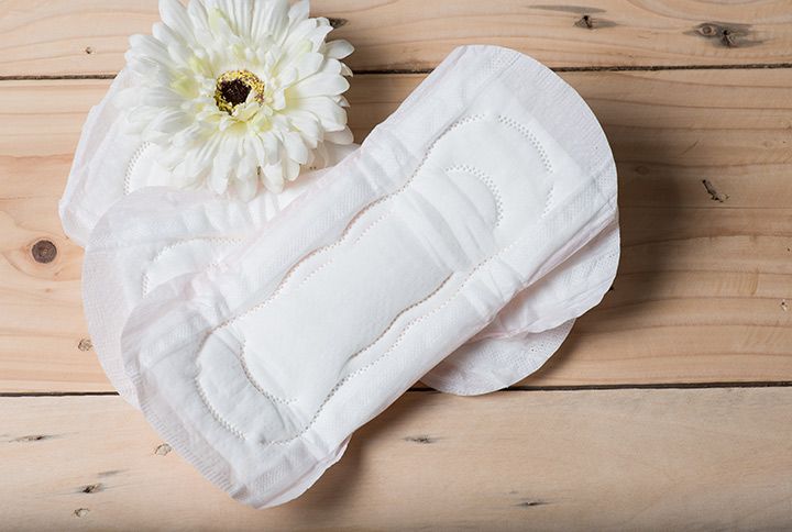 Sanitary napkins lying on a wooden table by Soonthronphoto | www.shutterstock.com