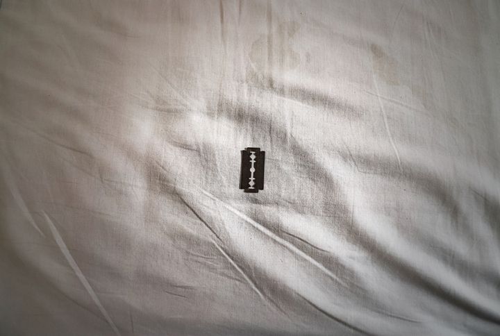 Razor on a white bedsheet By YoPho | www.shutterstock.com