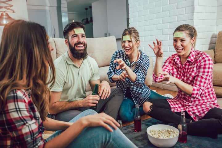 Friends playing games at a house party. By adriaticfoto | www.shutterstock.com