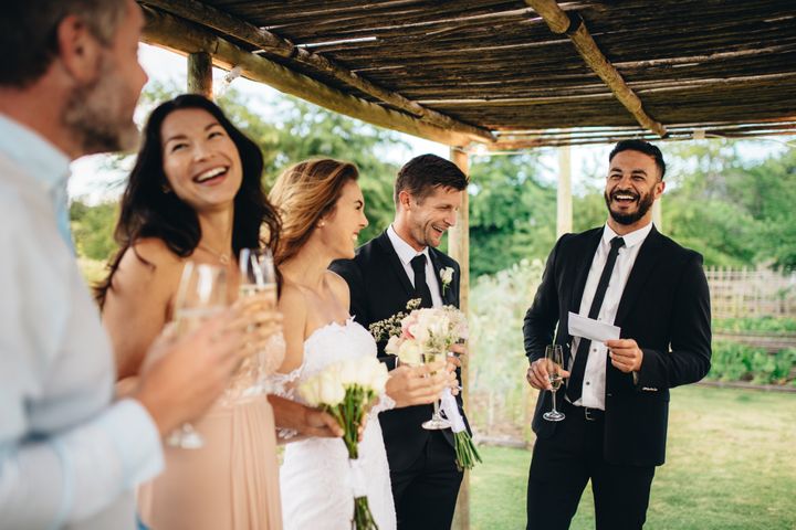 Best man giving speech to newlywed couple at wedding reception. By Jacob Lund | www.shutterstock.com