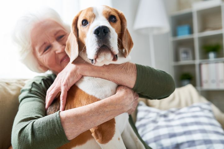Portrait of a senior woman hugging her pet dog tenderly By SeventyFour | www.shutterstock.com