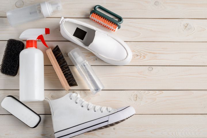 White shoes and cleaning tools: brushes, sponge and various sprays. By Yuriy Golub | www.shutterstock.com