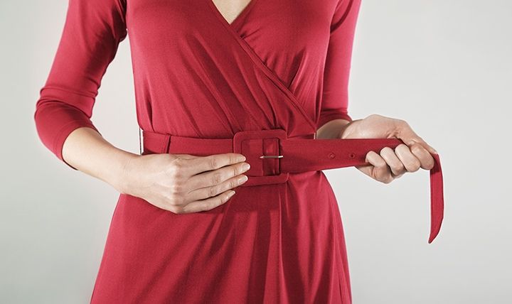 Mid-section of a Businesswoman Adjusting Belt by Sirtravelalot | www.shutterstock.com