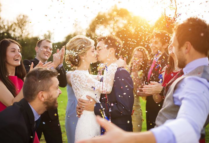 Wedding party showered with confetti By Halfpoint | www.shutterstock.com