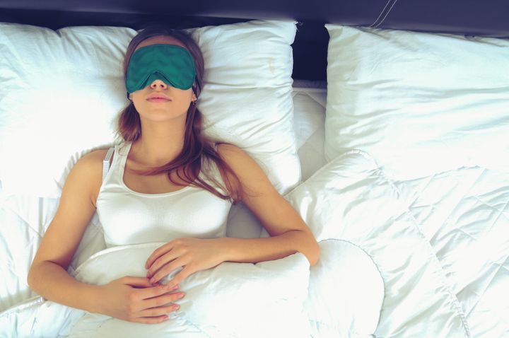 Young woman sleeping with an eye mask. By George Rudy | www.shutterstock.com