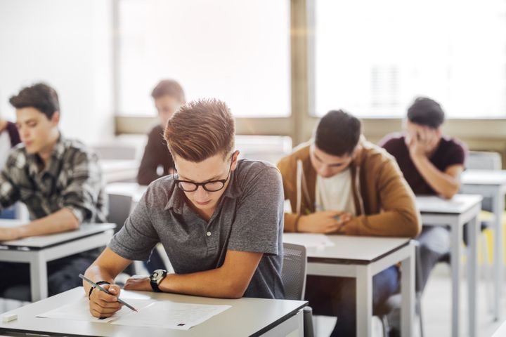 Group of student writing an exam. By LStockStudio | www.shutterstock.com