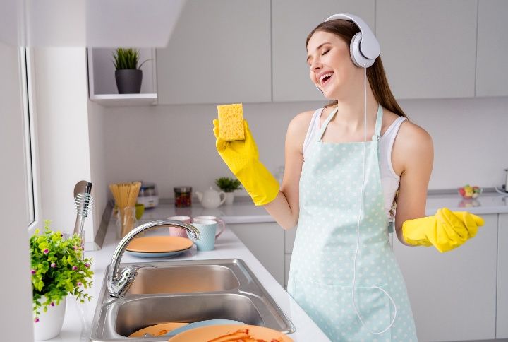 Girl Washing Dirty Plates With Yellow Latex Gloves By Roman Samborskyi | www.shutterstock.com