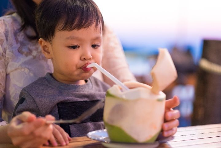 Kid Drinking Coconut Water By VasitChaya | www.shutterstock.com