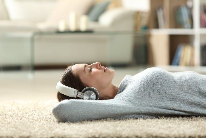 Woman Listening To Music Meditating By Pheelings media | www.shutterstock.com