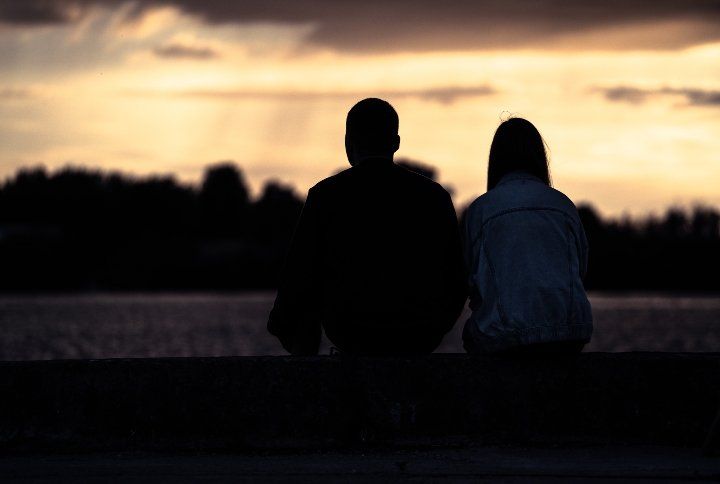Couple Watching Sunset By OlegRi | www.shutterstock.com